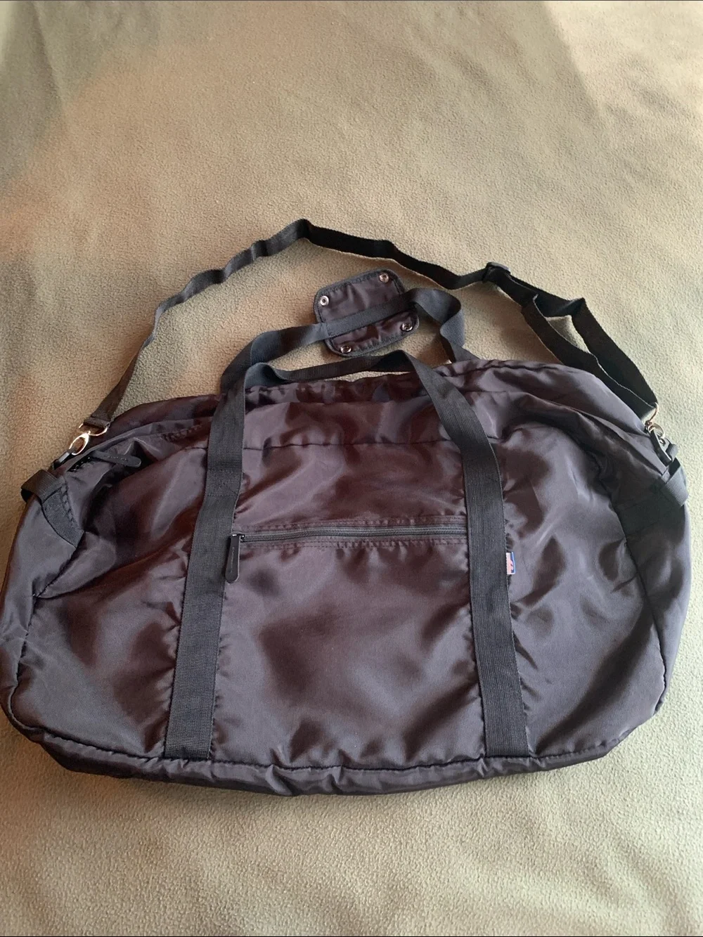 EUC black nylon duffel bag with strap. Approximately 22” x 14” x 10.5”